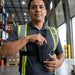 Warehouse worker wearing a Chest Harness Holster for Keyence Mobile Scanners with the pouch positioned securely on the front of the chest