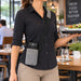 Server carrying Castles POS terminal in gray Agoz shoulder sling holster