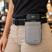 Close-up of Castles POS terminal secured in gray Agoz holster and waist belt