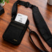 Black Agoz Clover Flex POS sling holster with padded shoulder strap on work surface