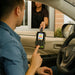 Customer using Shopify POS Terminal in AgozTech drive-thru handheld mount at drive-thru window