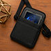 Black Getac tablet carrying case with shoulder sling on wood tabletop with rugged tablet in pocket