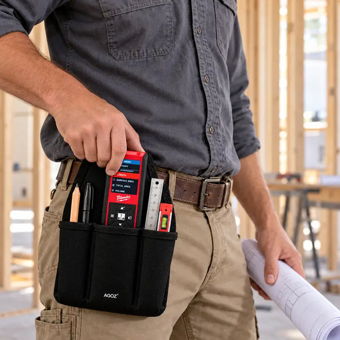 Close-up of construction worker removing a Milwaukee laser distance meter from a black Agoz utility tool pouch attached to his waist belt.