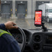 Point Mobile handheld computer mounted on a dashboard cradle holder inside a logistics truck.