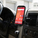 Point Mobile handheld computer secured in an AgozTech air vent cradle holder inside a delivery vehicle.