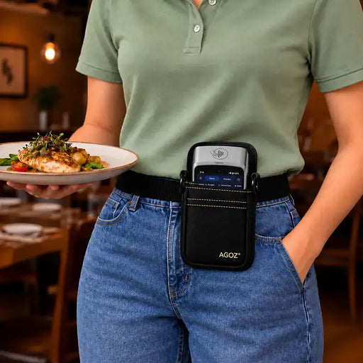 Restaurant server carrying a plated meal while wearing a black AGOZ SpotOn POS terminal holster secured to an adjustable nylon waist belt.