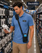A retail employee with a crossbody case for Elo handheld scanner checking a product in a store