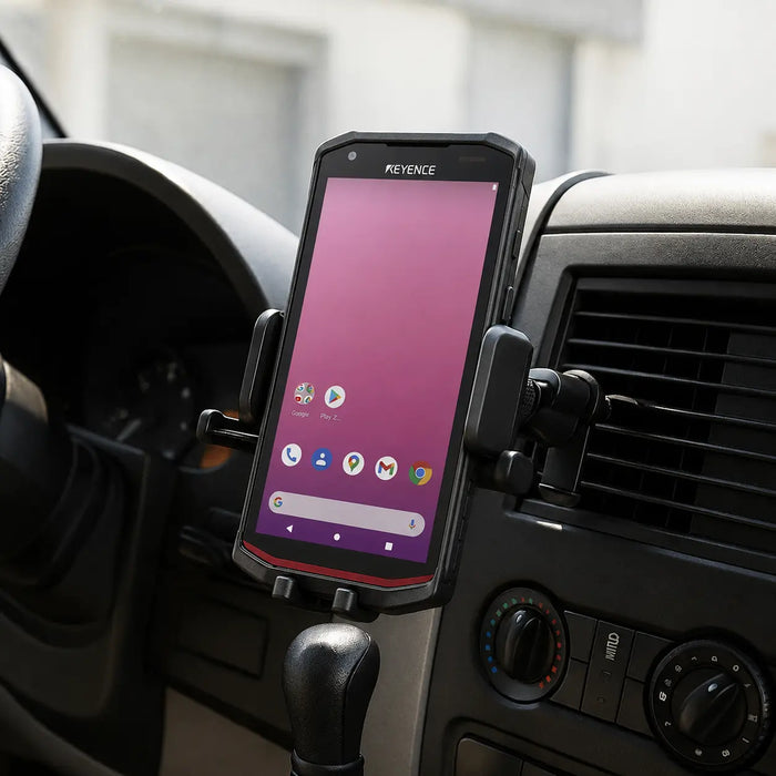 Keyence handheld computer secured in an air vent vehicle cradle holder inside a commercial vehicle.