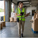 Service worker wearing a rugged WASP handheld scanner case with belt clip while reviewing tasks on a tablet in a warehouse loading area.