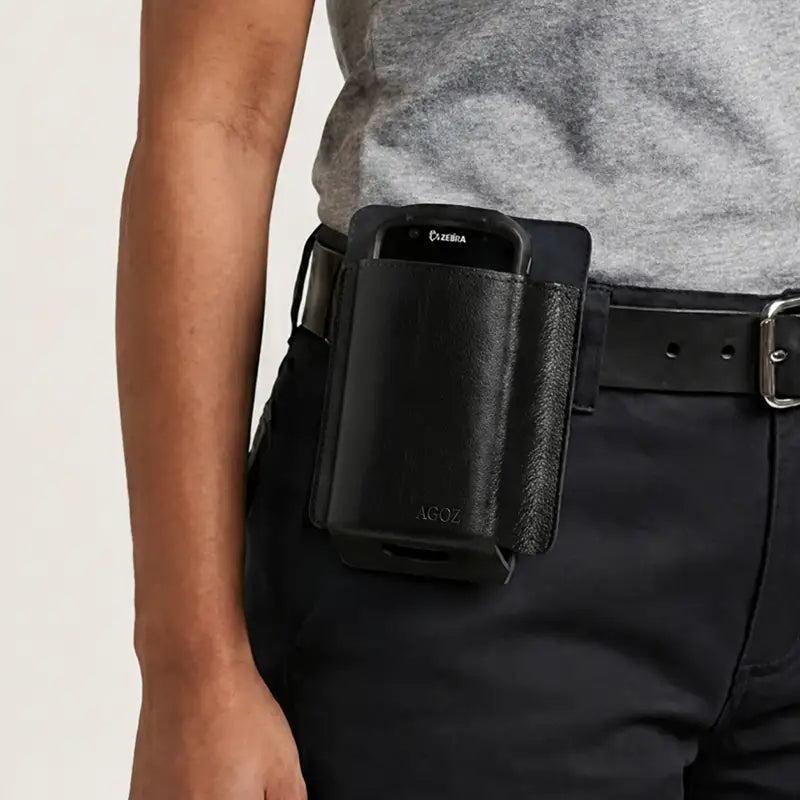 Zebra mobile computer seated in a black leather belt holster worn on a worker’s belt for hands-free carry.