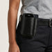 Zebra mobile computer seated in a black leather belt holster worn on a worker’s belt for hands-free carry.