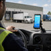 Unitech mobile scanner mounted in an AgozTech dashboard vehicle cradle inside a delivery vehicle near a loading dock.